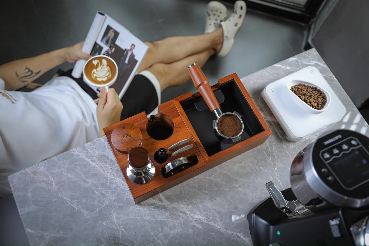 Rosewood tamping station and tools laid out on a marble bench
